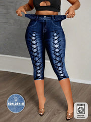 A woman wears capri-length leggings featuring a digital print of blue denim with lace-up details.