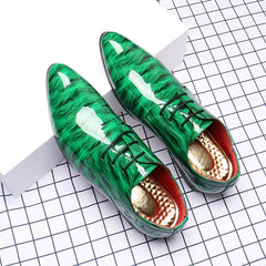 A pair of glossy green ripple-patterned men's lace-up dress shoes with pointed toes.