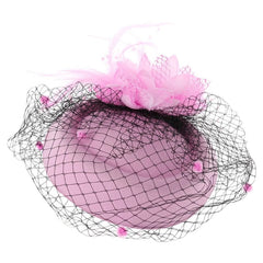 A pink pillbox fascinator hat adorned with a flower, feathers, and a black polka-dot veil.
