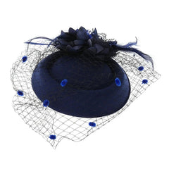 A navy blue pillbox fascinator hat adorned with a flower, feathers, and a dotted mesh veil.