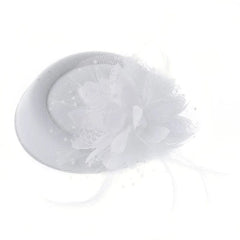 A white pillbox fascinator hat adorned with a floral accent, feathers, and a delicate mesh veil.