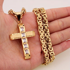 A gold-plated stainless steel cross pendant with rhinestone accents on a Byzantine chain.