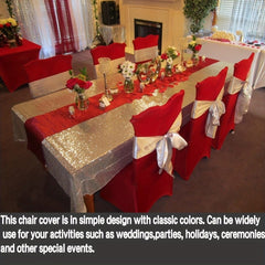 Red stretch chair covers with silver sashes displayed on chairs around a decorated banquet table.