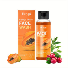 A bottle of Hoygi papaya extract face wash stands next to its orange box with fresh fruit nearby.