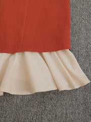 A red high-waisted skirt featuring a contrasting white ruffled hemline.