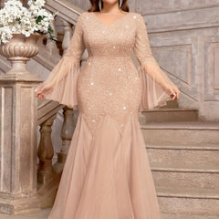 A plus-size champagne sequin lace mermaid gown with a V-neck and sheer bell sleeves.