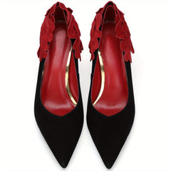 Black pointed-toe stiletto pumps featuring red floral petal accents around the heel collar.