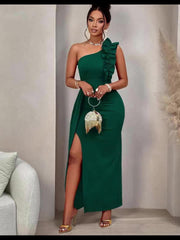 A woman wears a dark green, one-shoulder, bodycon maxi dress with a ruffle detail and side slit.