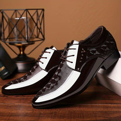 A pair of brown and white pointed-toe men's oxford shoes with lace-up closures and patterned panels.