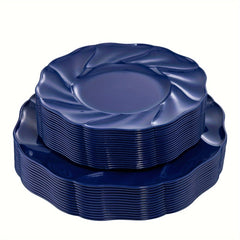 A stack of sixty round, navy blue plastic dinner and dessert plates with a scalloped edge.