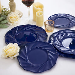 A set of round, blue plastic dinner and dessert plates with a decorative scalloped edge.