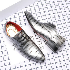 A pair of men's pointed-toe dress shoes featuring a glossy grey and white ripple pattern.