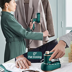 A portable green handheld steam iron shown being used for both vertical steaming and flat ironing.