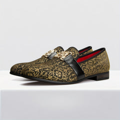 Black and gold floral loafers featuring a decorative gold buckle and red interior lining.