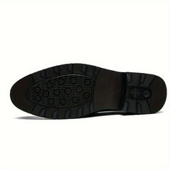 The black rubber outsole of a men's dress shoe features a textured tread and a small logo.