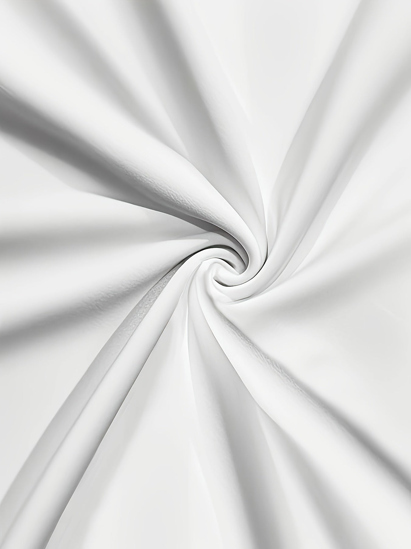A close-up view of smooth white fabric swirled into a spiral pattern.