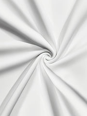 A close-up view of smooth white fabric swirled into a spiral pattern.