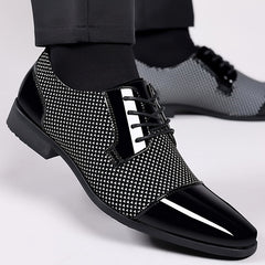 Black and white lace-up Oxford dress shoes with a glossy toe cap and patterned side panels.