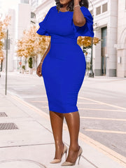A woman wears a royal blue midi pencil dress with ruffle sleeves and a round neckline.