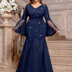 A navy blue plus size mermaid gown featuring sequin lace, a V-neck, and sheer bell sleeves.