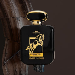 A black rectangular perfume bottle with a gold horse emblem and cap against a dark background.