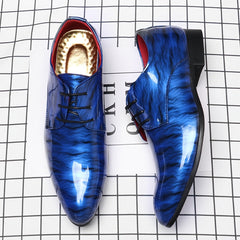 A pair of glossy blue dress shoes with a ripple pattern, pointed toes, and black lace-up closures.