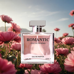 A square glass bottle of Romantic Pour Femme perfume sits centered in a field of pink flowers.