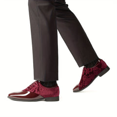A pair of burgundy velvet and glossy patent leather men's dress shoes with lace-up closures.
