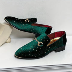 A pair of green velvet slip-on loafers featuring gold studs and a metallic horsebit detail.