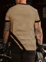 A tan short-sleeve crew neck t-shirt with white polka dots and dark brown contrast accents.