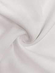 A close-up view of smooth, solid white woven polyester fabric with soft, elegant folds.