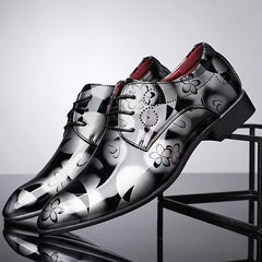 Men's pointed-toe faux leather oxford dress shoes featuring a black and silver floral pattern.