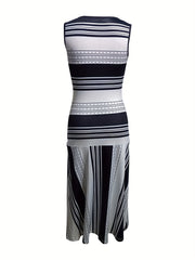 A sleeveless, crew-neck midi dress featuring a black and white striped patchwork pattern.