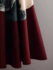 A flowy A-line midi skirt featuring a beige and red floral print with button details.