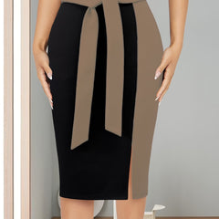 A slim-fit black midi skirt featuring a tan color-block side panel and a matching ribbon tie.