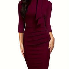 A burgundy three-quarter sleeve sheath dress with a high tie-neck and draped side detailing.