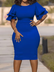 A woman wears a royal blue midi pencil dress featuring a round neck and short ruffle sleeves.