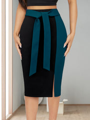 A black and teal color-block midi skirt with a high waist and an adjustable ribbon bow detail.