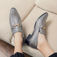 A pair of men's silver metallic scale-pattern slip-on loafers with gold-tone horsebit hardware.