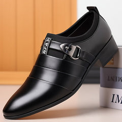 A black pointed-toe men's formal shoe with a buckle strap and a low-top design.