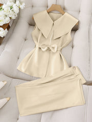 A beige sleeveless top with a wide collar and bow waist paired with matching long pants.