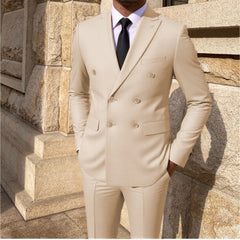 A man wears a beige double-breasted suit with a white shirt and black tie.