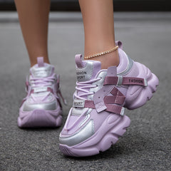 A pair of light purple and silver chunky lace-up sneakers with fashion sport lettering.