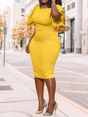 A woman wears a yellow midi-length bodycon pencil dress with short ruffle sleeves.