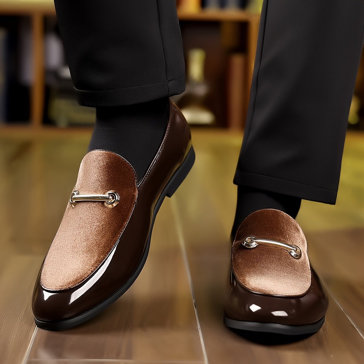 A pair of brown slip-on loafers featuring a velvet-textured vamp and a gold-tone metal bit.