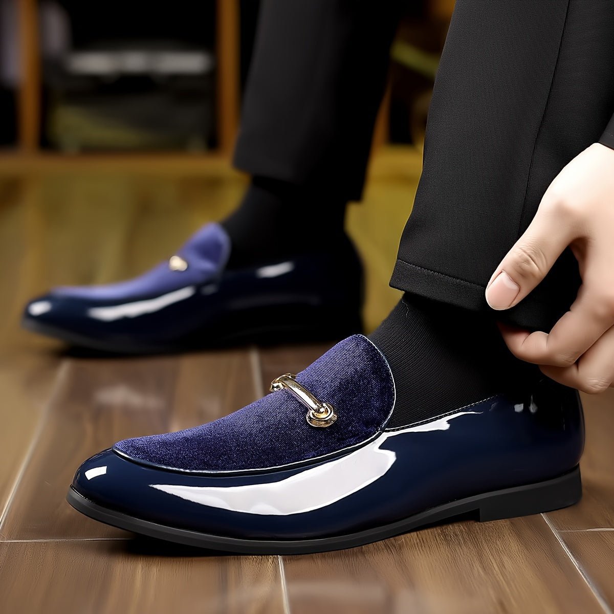 A pair of navy blue slip-on loafers featuring a velvet-textured vamp and a gold-tone metal bit.