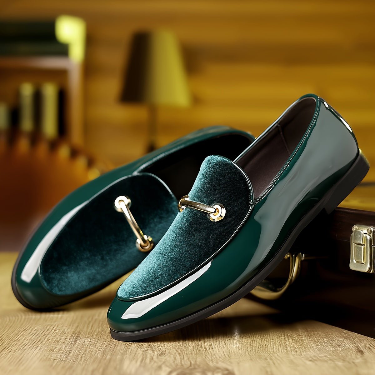 A pair of dark green slip-on loafers featuring a velvet vamp and a gold-tone metal bit detail.