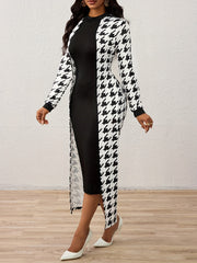 A woman wears a black knee-length dress paired with a long-sleeved houndstooth cape.