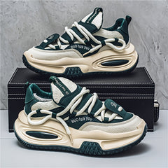 A pair of chunky, dark green and cream-colored lace-up dad sneakers with thick rubber soles.