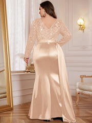 A plus-size champagne gown with a sequin lace bodice, long sleeves, and a satin mermaid skirt.